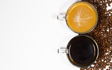 Two coffee mugs one black and one with cream with coffee beans on white background with copy space