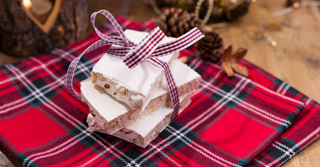Nougat and almonds for a holiday in evroppe. Christmas sweets with nuts and decor. Free space for text.