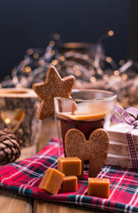 Fresh aromatic coffee and Italian Christmas sweets. Nougat with almonds, karemelnye sweets, ginger cookies and hot drink. Candles and holiday decorations. Free space for text.