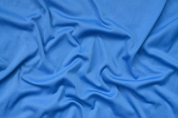 Detailed polyester blue fabric texture with many folds