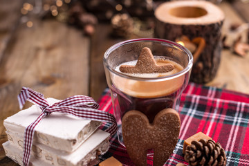 Fresh aromatic coffee and Italian Christmas sweets. Nougat with almonds, karemelnye sweets, ginger cookies and hot drink. Candles and holiday decorations. Free space for text.