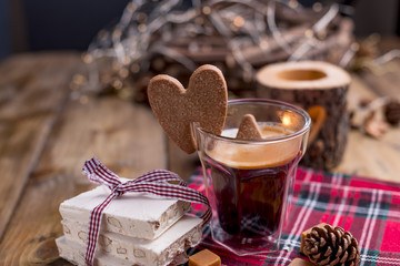 Fresh aromatic coffee and Italian Christmas sweets. Nougat with almonds, karemelnye sweets, ginger cookies and hot drink. Candles and holiday decorations. Free space for text.