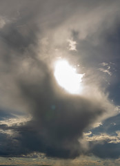 the sun making its way through the rain cloud