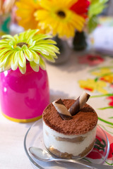 Tiramisu cake with an artificial flowers