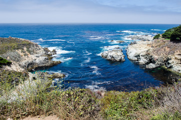 Fototapeta na wymiar Bright blue water in the Pacific Ocean near Big Sur California along the Pacific Coast Highway