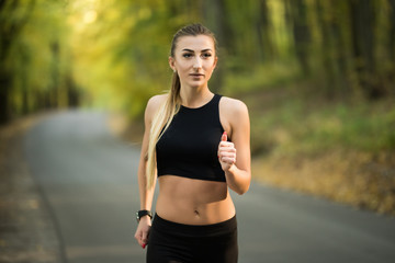 Runner athlete running at green park. Fitness woman fitness sunrise jogging workout wellness concept.
