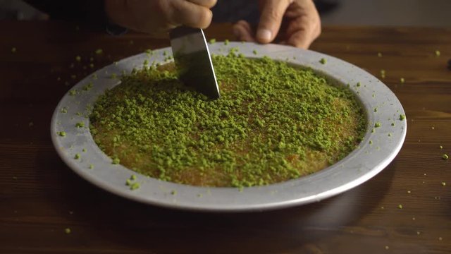 Famous dessert KUNEFE aka KUNEFAH. Cheese with thin pastry cooked, sweetened with sugar syrup, melted saltless cheese dessert from middle east. 