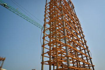 bundle of reinforced components and crane in a construction site