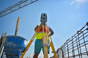 Surveyor engineers working with total station on a construction site