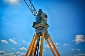 Survey equipment for precise measurement on  clouded sky background