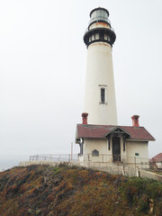 Pigeon Point Lighthouse on California central coast on an overcast foggy morning in the summer.