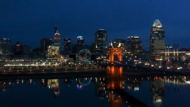 Slow tracking shot of Cincinnati skyline in the evening with water reflection