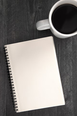 A Blank Notebook Laid on a Black Wooden Table