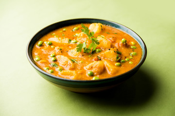 Indian Aloo Mutter curry - Potato and Peas immersed in an Onion Tomato Gravy and garnished with...