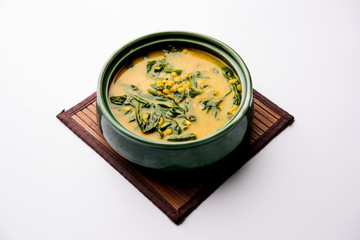 Dal Palak or Lentil spinach curry - popular Indian main course healthy recipe. served in a karahi/pan or bowl. selective focus