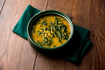 Dal Palak or Lentil spinach curry - popular Indian main course healthy recipe. served in a karahi/pan or bowl. selective focus