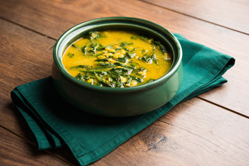 Dal Palak or Lentil spinach curry - popular Indian main course healthy recipe. served in a karahi/pan or bowl. selective focus