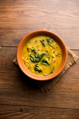 Dal Palak or Lentil spinach curry - popular Indian main course healthy recipe. served in a karahi/pan or bowl. selective focus