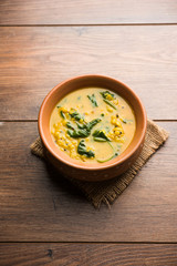 Dal Palak or Lentil spinach curry - popular Indian main course healthy recipe. served in a karahi/pan or bowl. selective focus