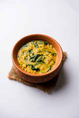 Dal Palak or Lentil spinach curry - popular Indian main course healthy recipe. served in a karahi/pan or bowl. selective focus