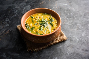 Dal Palak or Lentil spinach curry - popular Indian main course healthy recipe. served in a karahi/pan or bowl. selective focus