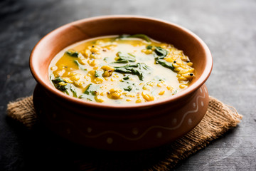 Dal Palak or Lentil spinach curry - popular Indian main course healthy recipe. served in a karahi/pan or bowl. selective focus