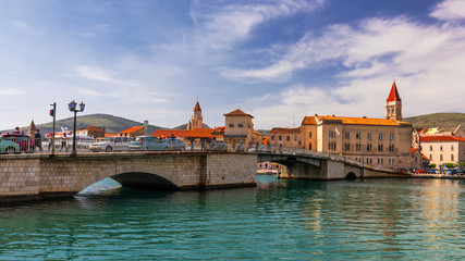 Obraz premium Historic buildings on promenade in Trogir, Croatia. Trogir is popular travel destination in Croatia. Trogir, as a UNESCO World Heritage Site, is one of most visited places in Dalmatia, Croatia.