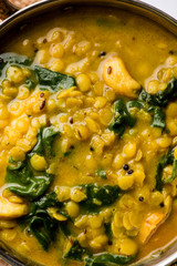 Dal Palak or Lentil spinach curry - popular Indian main course healthy recipe. served in a karahi/pan or bowl. selective focus
