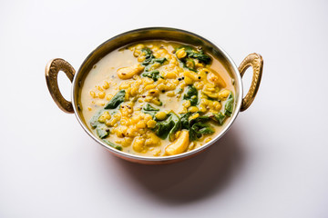 Dal Palak or Lentil spinach curry - popular Indian main course healthy recipe. served in a karahi/pan or bowl. selective focus