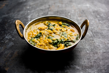 Dal Palak or Lentil spinach curry - popular Indian main course healthy recipe. served in a karahi/pan or bowl. selective focus