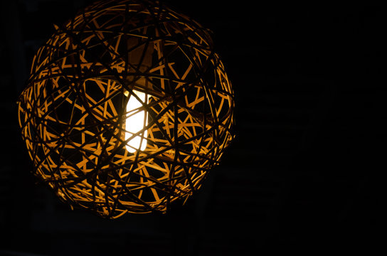 Rustic lamp, light, dark background.