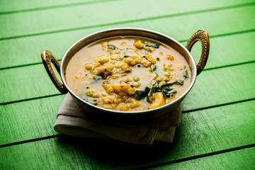 Dal Palak or Lentil spinach curry - popular Indian main course healthy recipe. served in a karahi/pan or bowl. selective focus