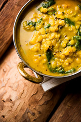Dal Palak or Lentil spinach curry - popular Indian main course healthy recipe. served in a karahi/pan or bowl. selective focus