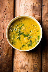 Dal Palak or Lentil spinach curry - popular Indian main course healthy recipe. served in a karahi/pan or bowl. selective focus