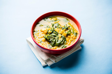 Dal Palak or Lentil spinach curry - popular Indian main course healthy recipe. served in a karahi/pan or bowl. selective focus