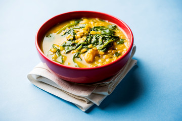 Dal Palak or Lentil spinach curry - popular Indian main course healthy recipe. served in a karahi/pan or bowl. selective focus