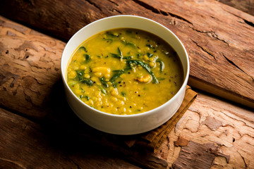 Dal Palak or Lentil spinach curry - popular Indian main course healthy recipe. served in a karahi/pan or bowl. selective focus