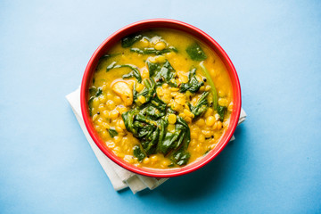 Dal Palak or Lentil spinach curry - popular Indian main course healthy recipe. served in a karahi/pan or bowl. selective focus