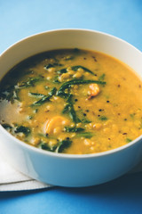 Dal Palak or Lentil spinach curry - popular Indian main course healthy recipe. served in a karahi/pan or bowl. selective focus