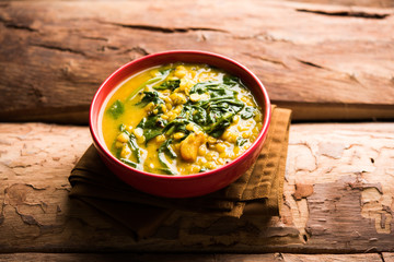 Dal Palak or Lentil spinach curry - popular Indian main course healthy recipe. served in a karahi/pan or bowl. selective focus