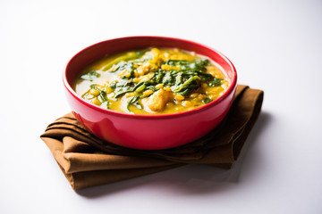 Dal Palak or Lentil spinach curry - popular Indian main course healthy recipe. served in a karahi/pan or bowl. selective focus