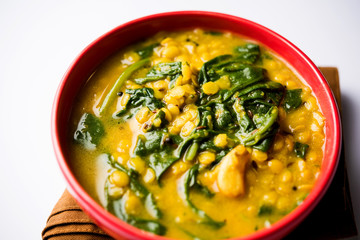 Dal Palak or Lentil spinach curry - popular Indian main course healthy recipe. served in a karahi/pan or bowl. selective focus