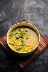 Dal Palak or Lentil spinach curry - popular Indian main course healthy recipe. served in a karahi/pan or bowl. selective focus