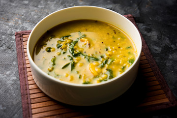 Dal Palak or Lentil spinach curry - popular Indian main course healthy recipe. served in a karahi/pan or bowl. selective focus