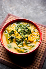 Dal Palak or Lentil spinach curry - popular Indian main course healthy recipe. served in a karahi/pan or bowl. selective focus