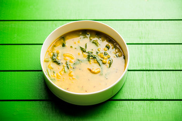 Dal Palak or Lentil spinach curry - popular Indian main course healthy recipe. served in a karahi/pan or bowl. selective focus