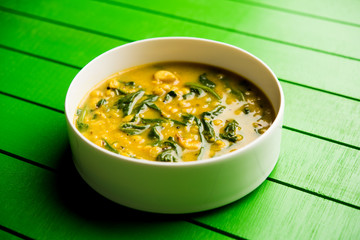 Dal Palak or Lentil spinach curry - popular Indian main course healthy recipe. served in a karahi/pan or bowl. selective focus