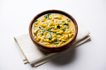 Dal Palak or Lentil spinach curry - popular Indian main course healthy recipe. served in a karahi/pan or bowl. selective focus