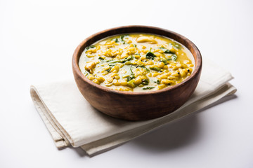 Dal Palak or Lentil spinach curry - popular Indian main course healthy recipe. served in a karahi/pan or bowl. selective focus