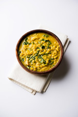 Dal Palak or Lentil spinach curry - popular Indian main course healthy recipe. served in a karahi/pan or bowl. selective focus